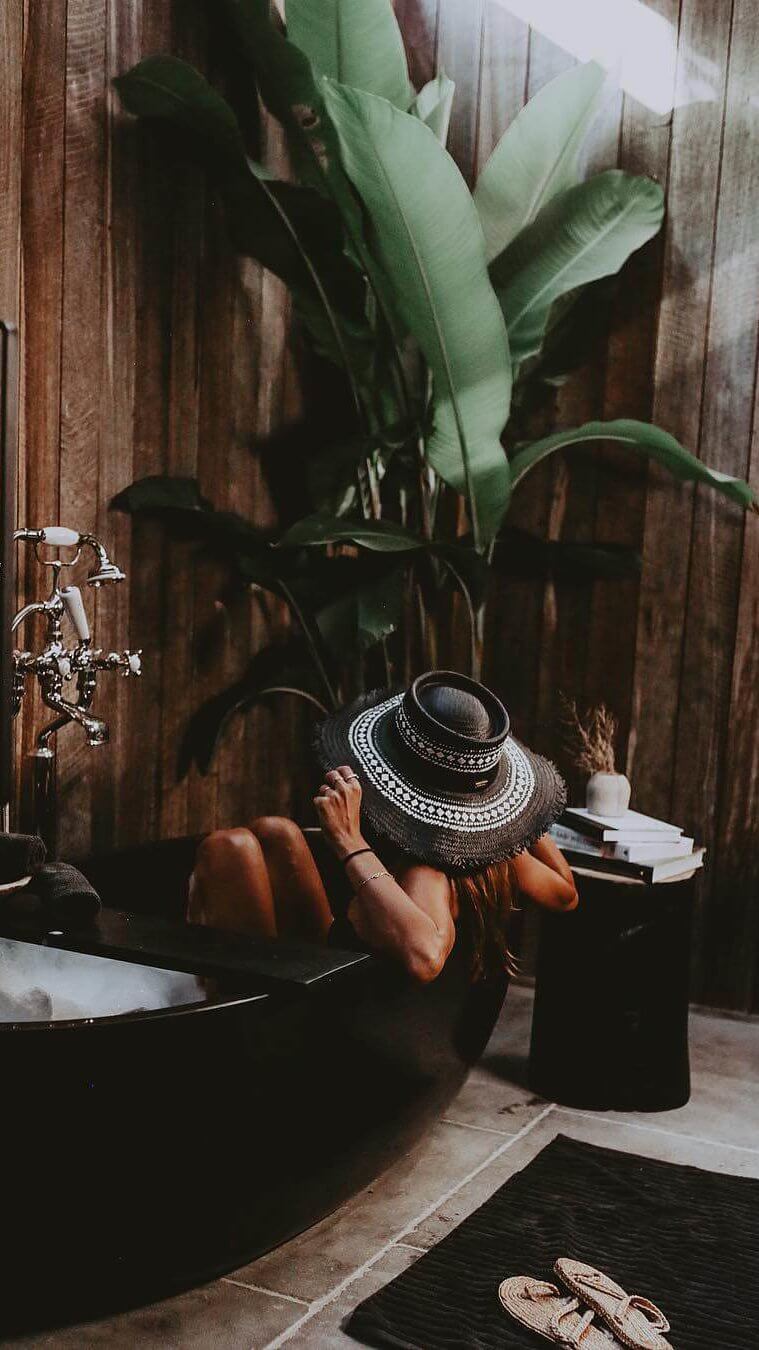 Andi Csinger in black stone bathtub at The Cabin, Byron Beach Abodes