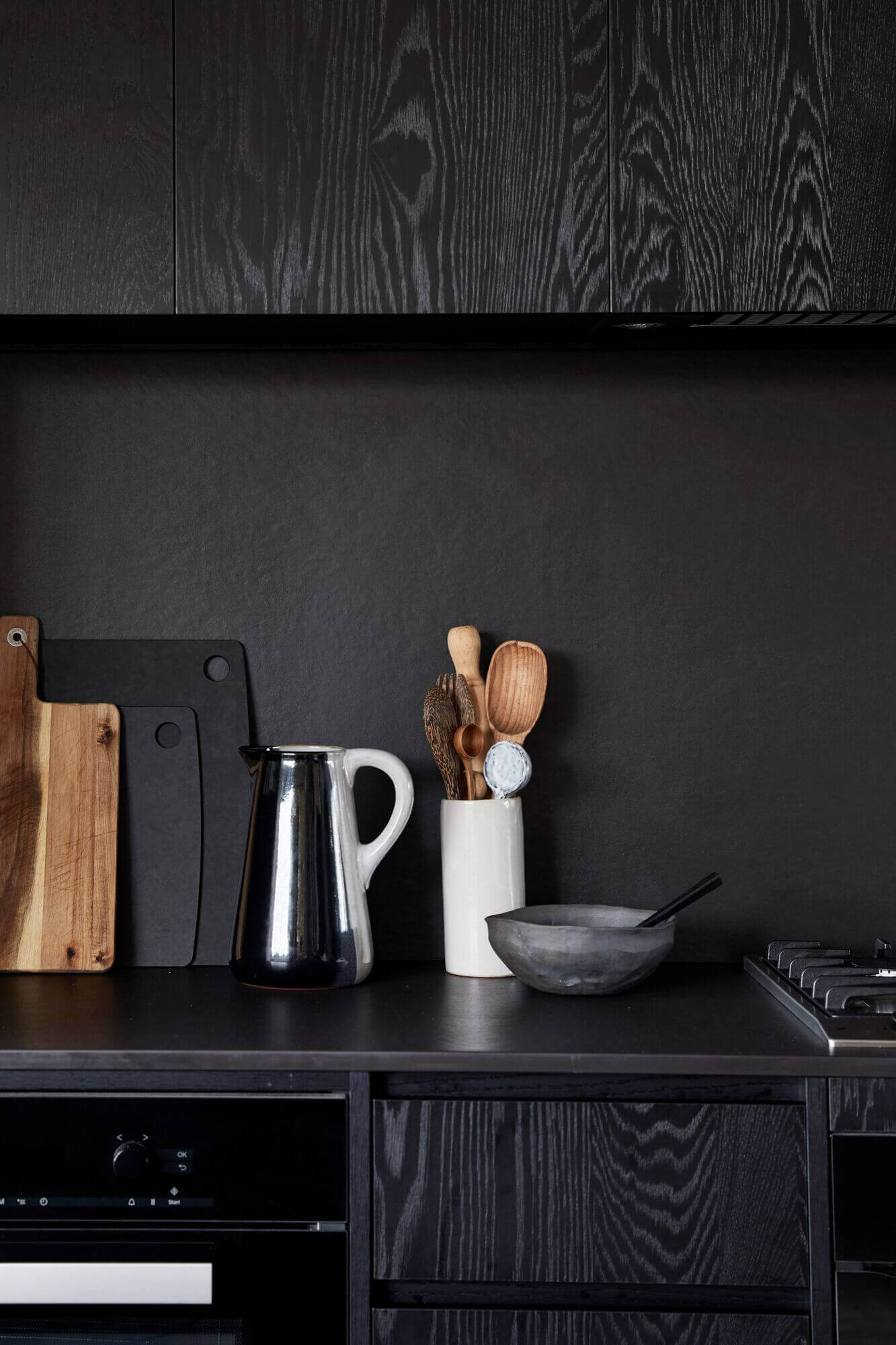 Black kitchen and splashback at The Cabin, Byron Beach Abodes