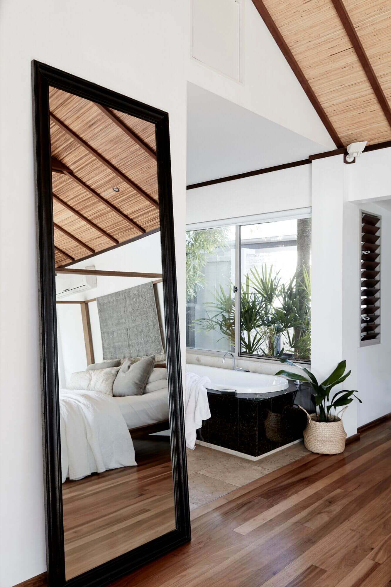Luxurious bedroom connected to the open ensuite with bath and heated marble floors at The Villas of Byron