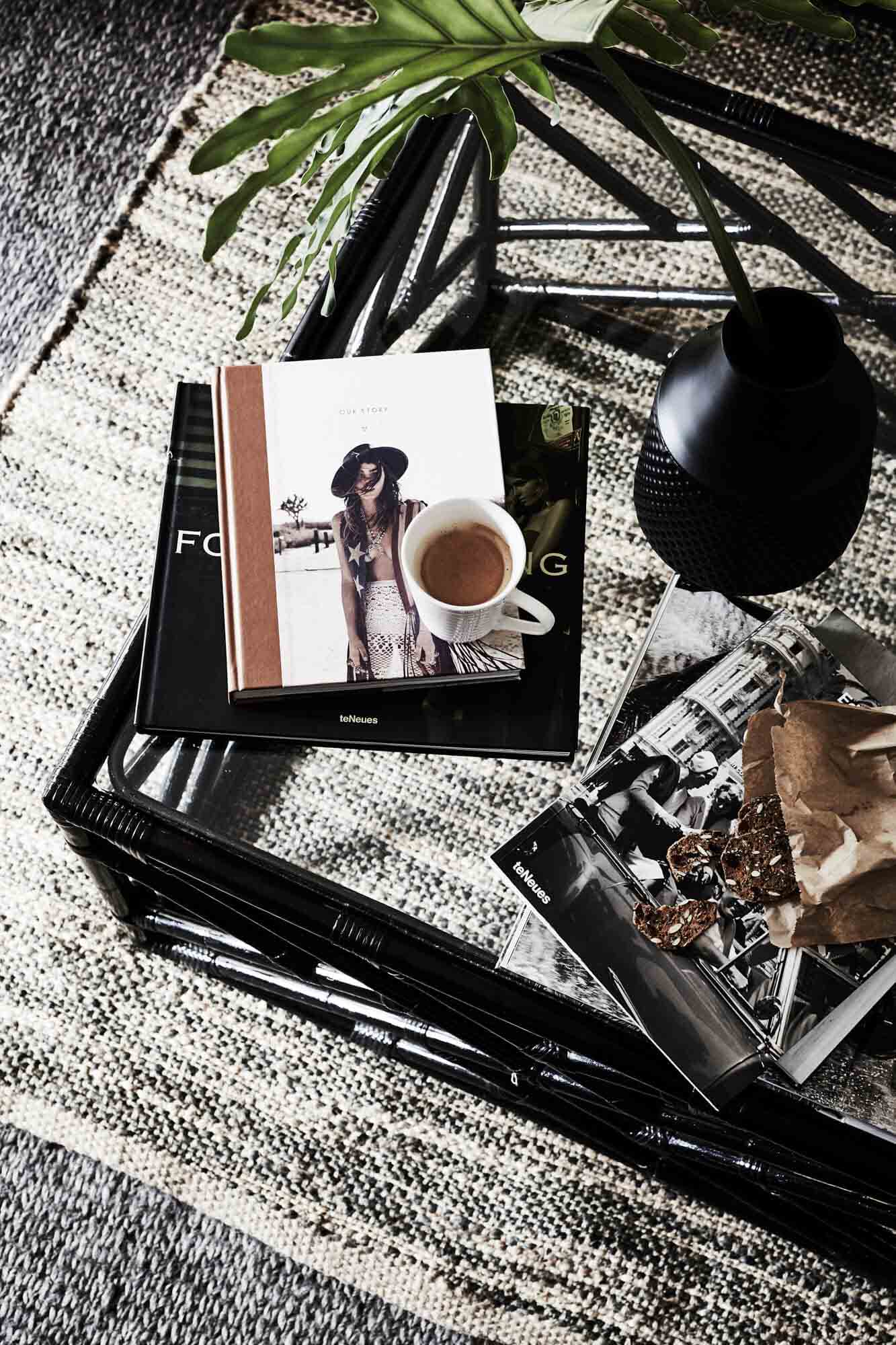 Textured rug and black cane coffee table at The Villas of Byron