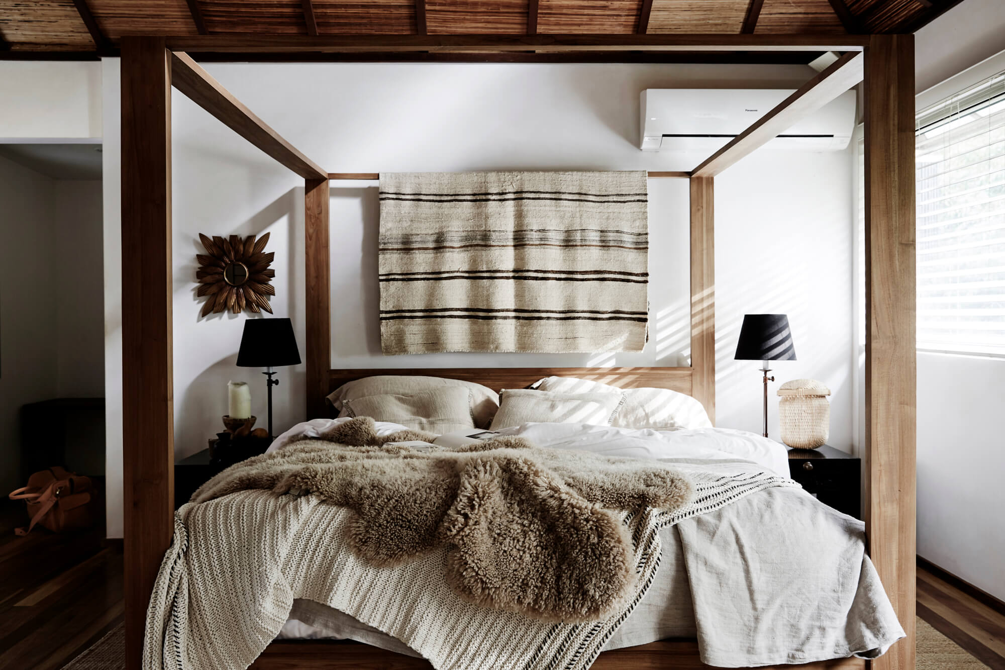 King-size four-posted bed with layers of luxury linen at The Villas of Byron