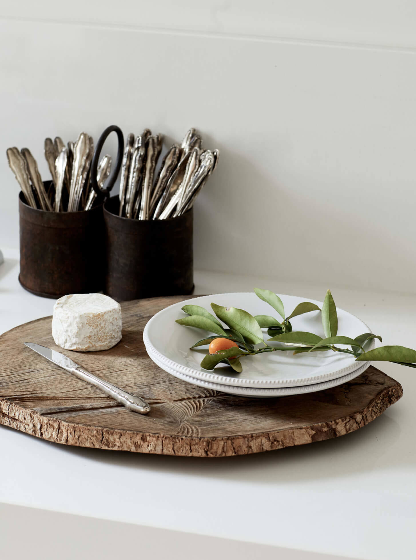 Vintage cutlery and cheese board with citrust picked fresh from the on-site orchard