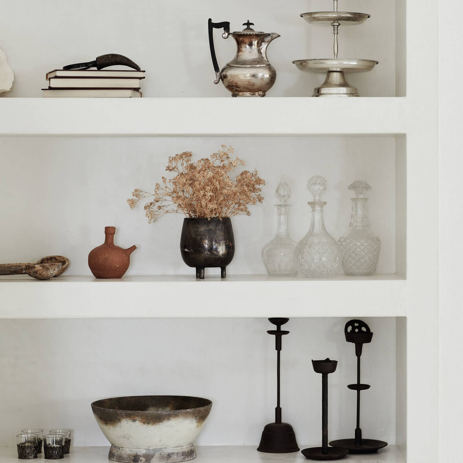 Custom, recessed wall shelving with antique, vintage and unique pieces on display