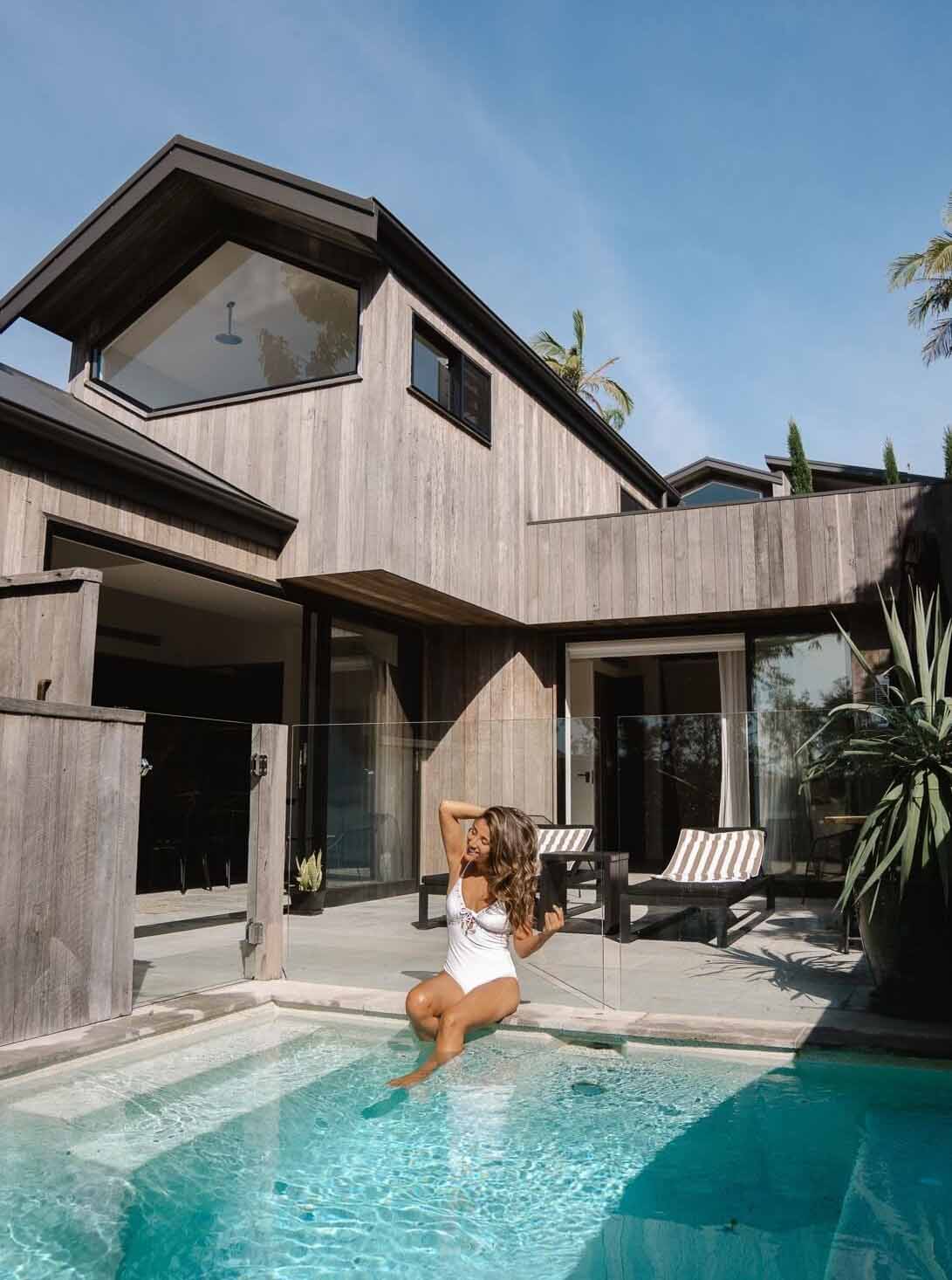Adriana Maria sitting poolside at The Cabin, Byron Beach Abodes