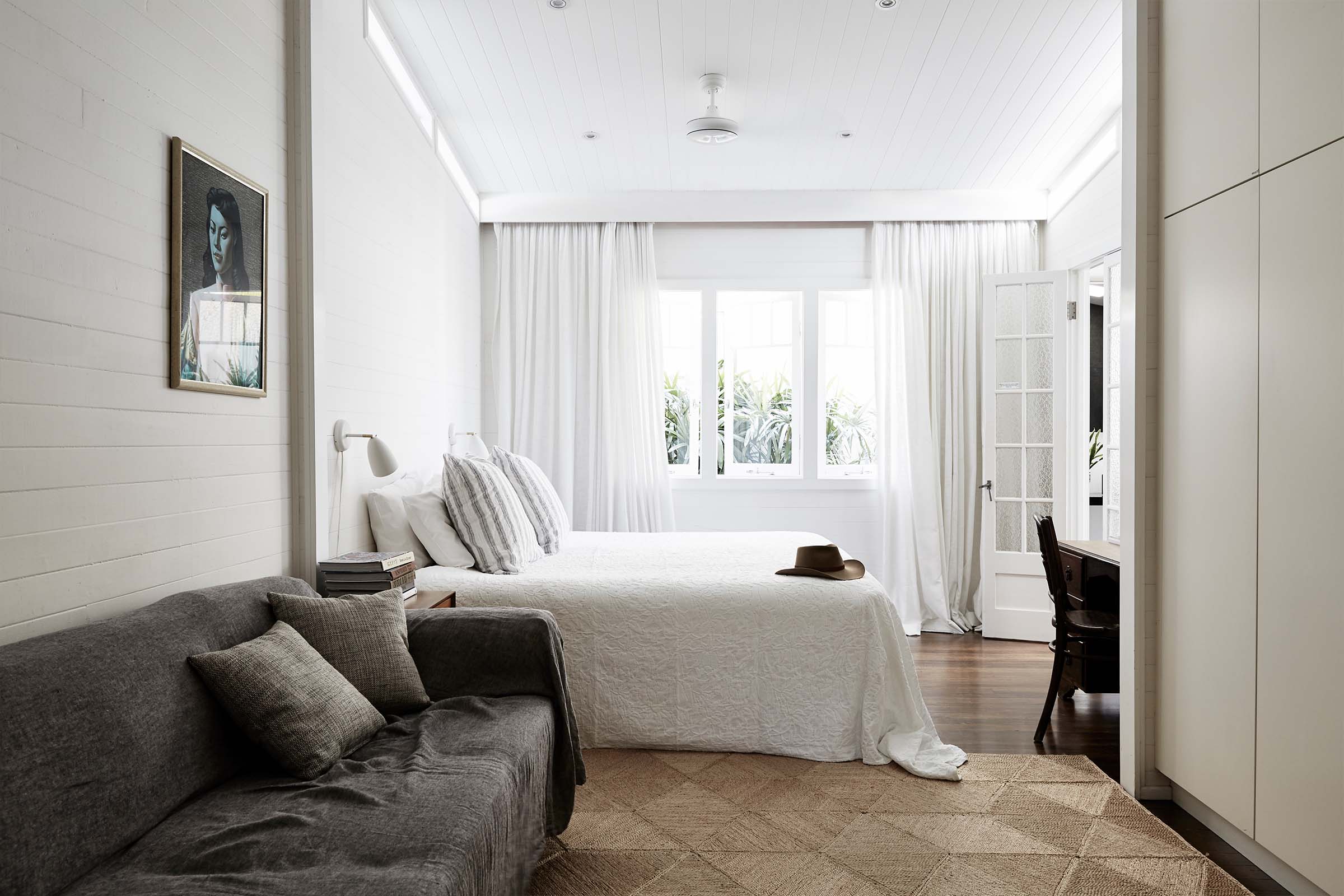 Master bedroom at The Cottage, Byron Beach Abodes with lounge area