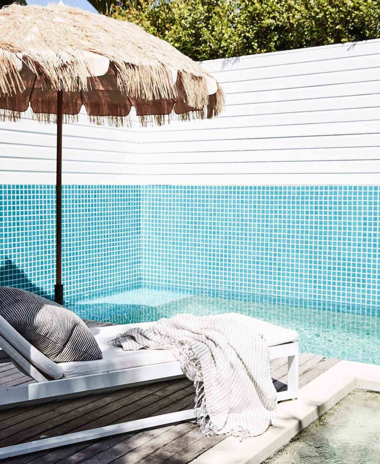 Vintage fringed umbrella beside the pool at The Cottage, Byron Beach Abodes
