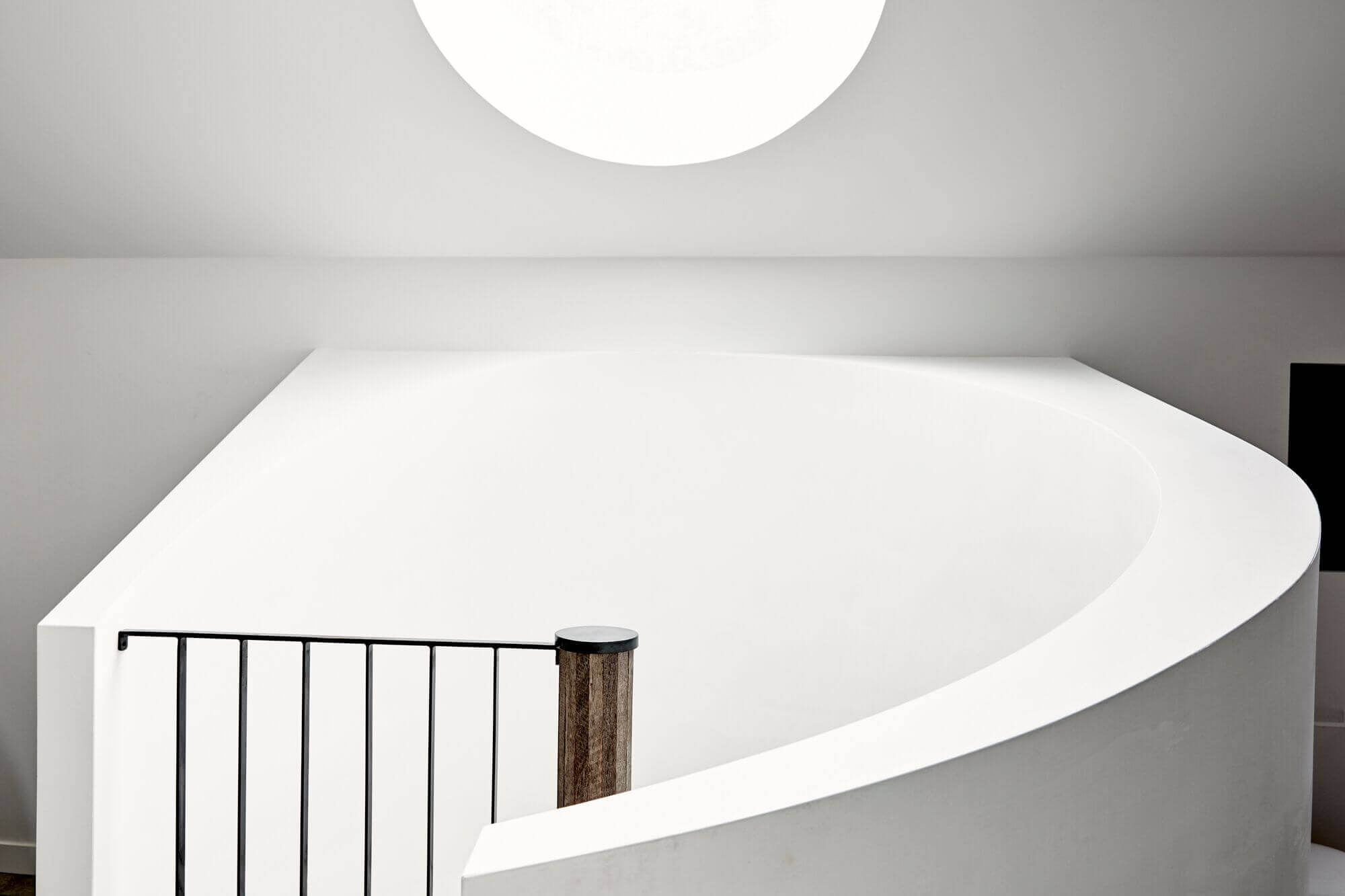 Custom curved limewash staircase and round skylight at The Cabin, Byron Beach Abodes
