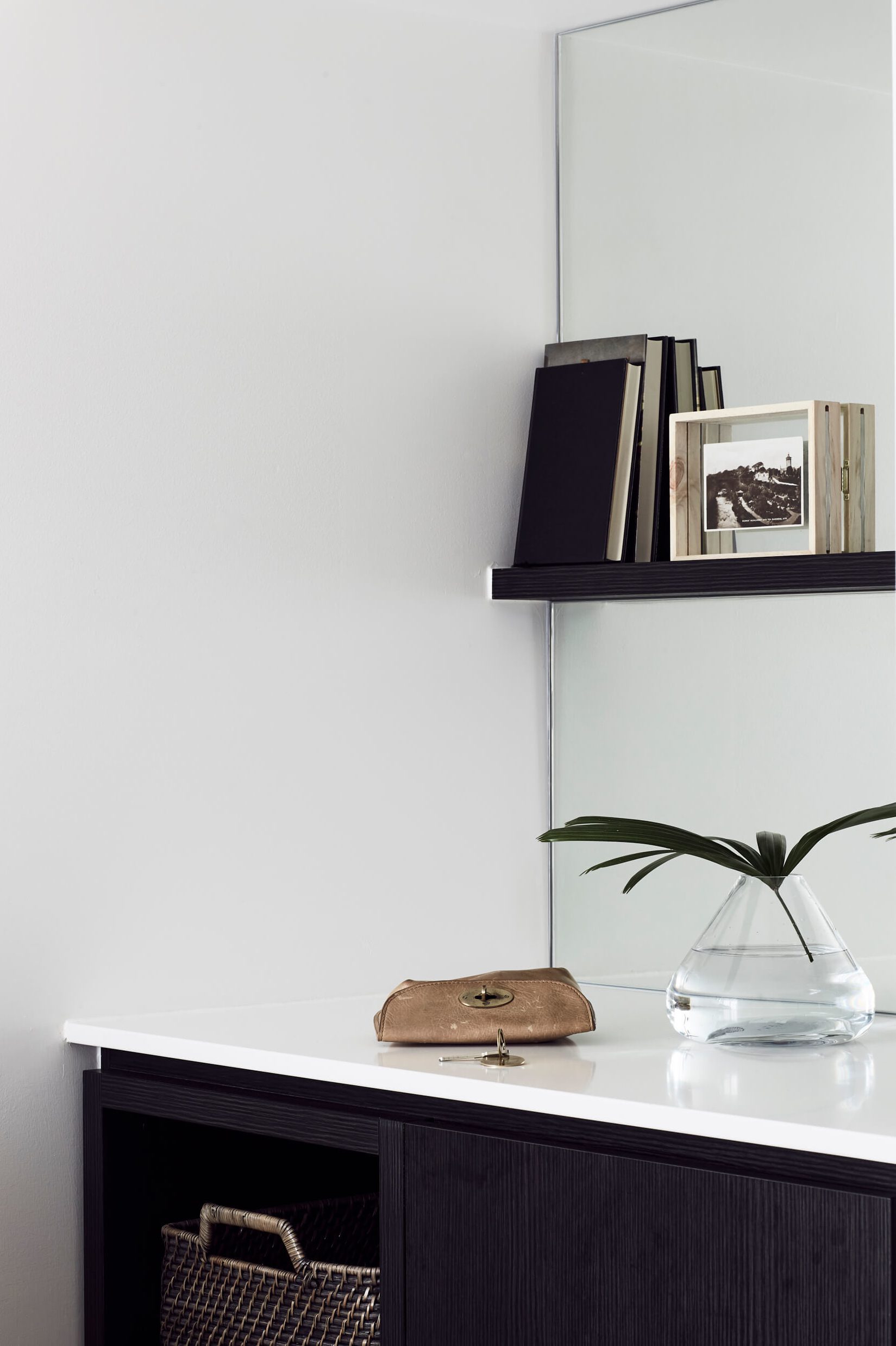 Kitchenette at the Bower Suites, The Bower Byron Bay hotel with mirrores splash back and timber shelf, books and greenery