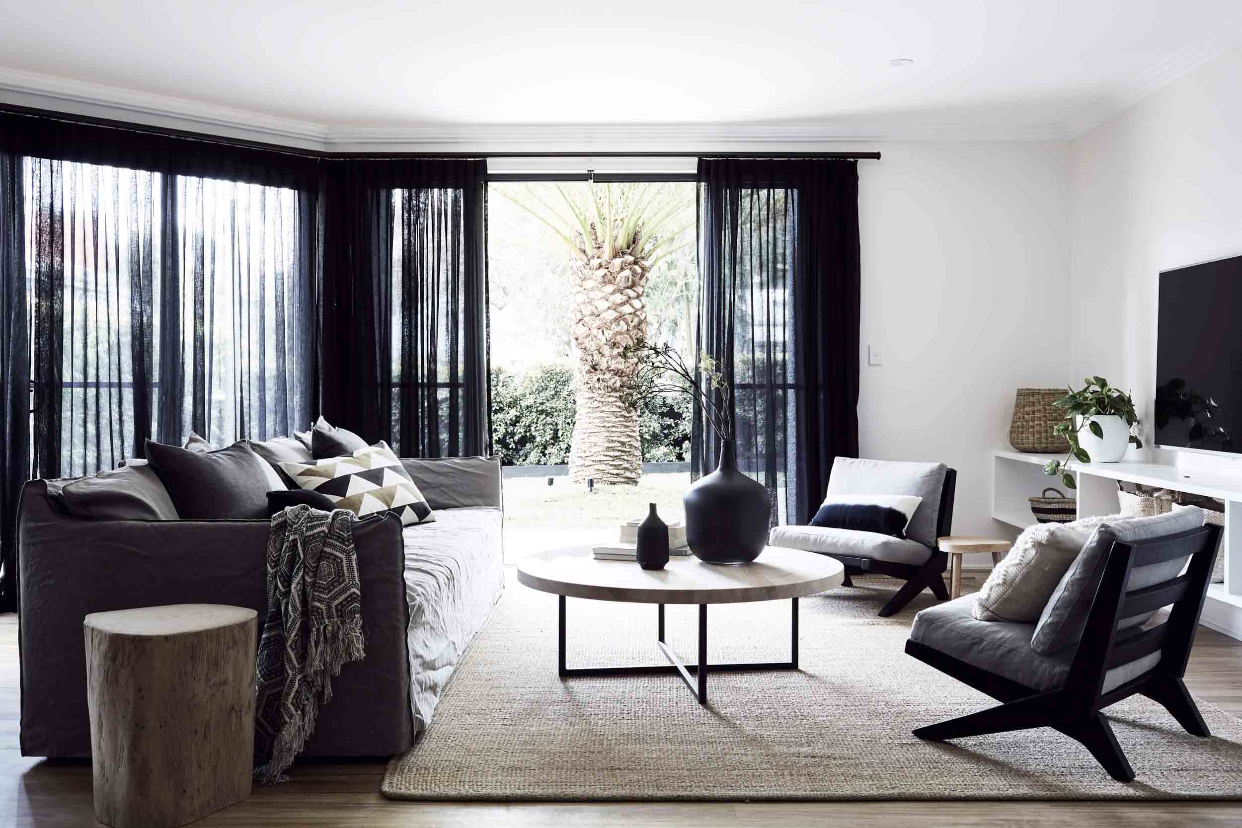 Open-plan lounge room at the Bower House, The Bower Byron Bay overlooking the huge palm tree in the courtyard