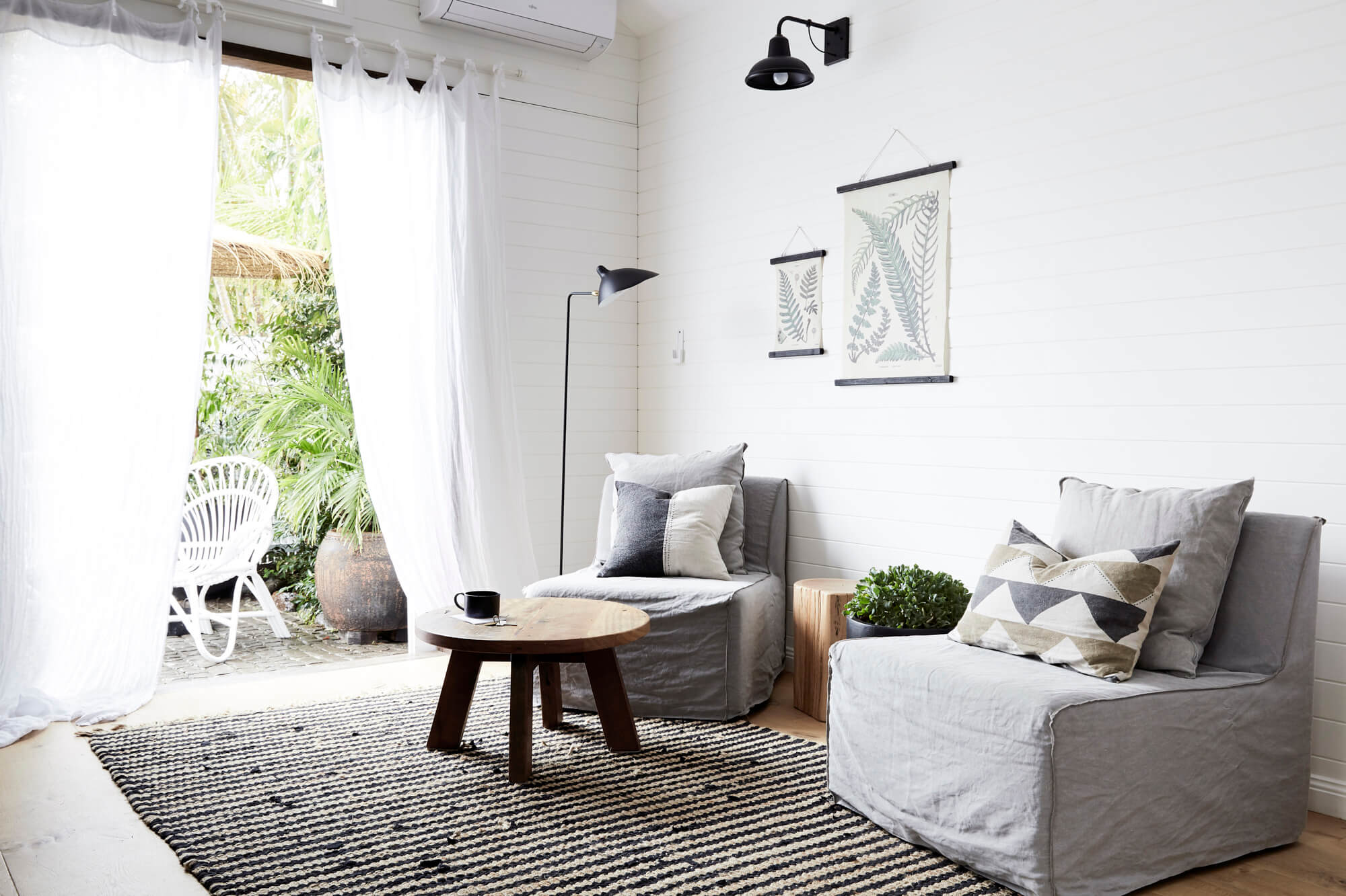 Sitting area at the Bower Barn, The Bower Byron Bay hotel with grey MCM Joe slipper chairs