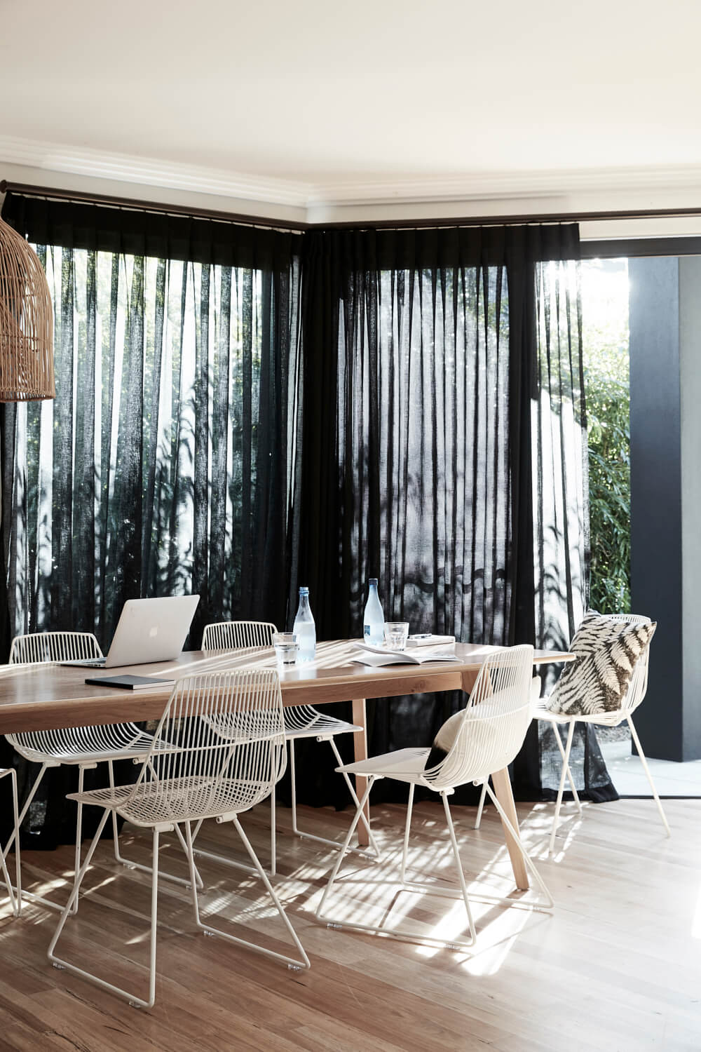 Dining room framed by floor to ceiling black curtains