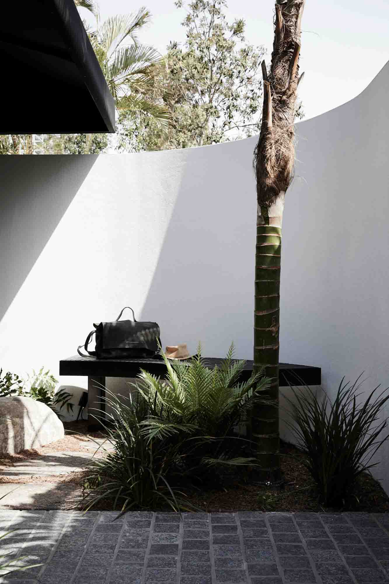 Curved rendered wall at the entrance to the Bower Studios, The Bower Byron Bay hotel