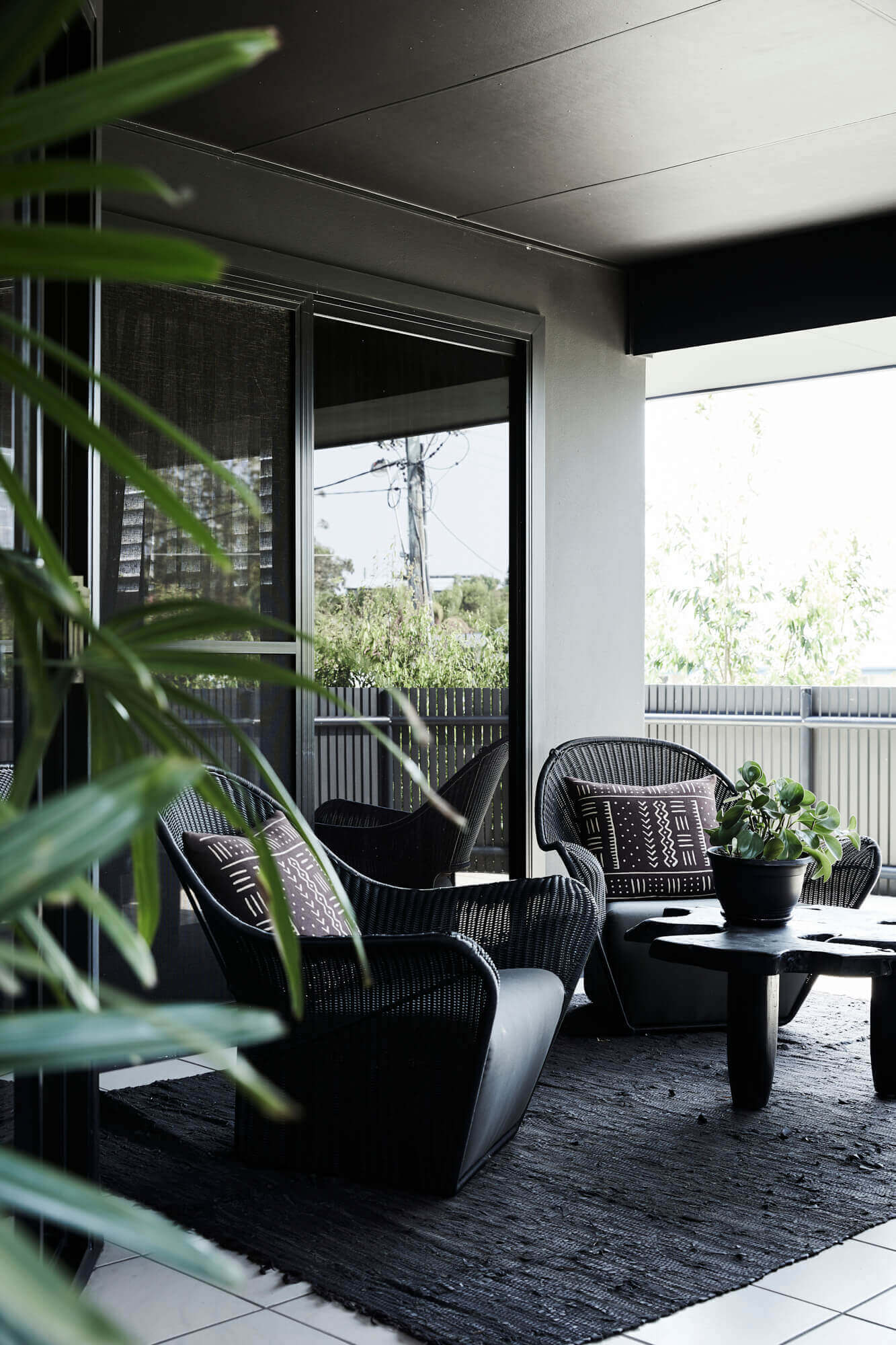Beautiful outdoor armchairs and timber coffee table on the upstairs balcony of the Bower House, The Bower Byron Bay
