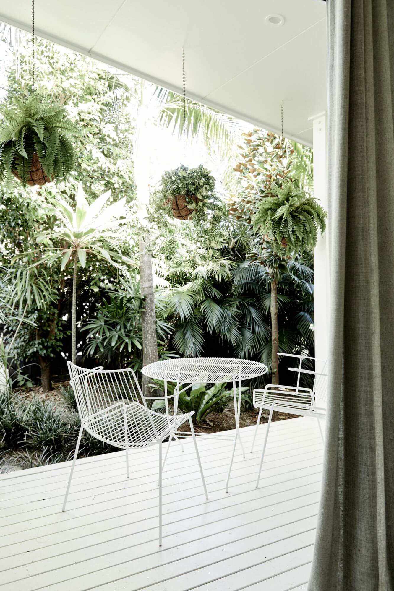 Private courtyard off a bedroom at The Chalet, Byron Beach Abodes overlooking the garden