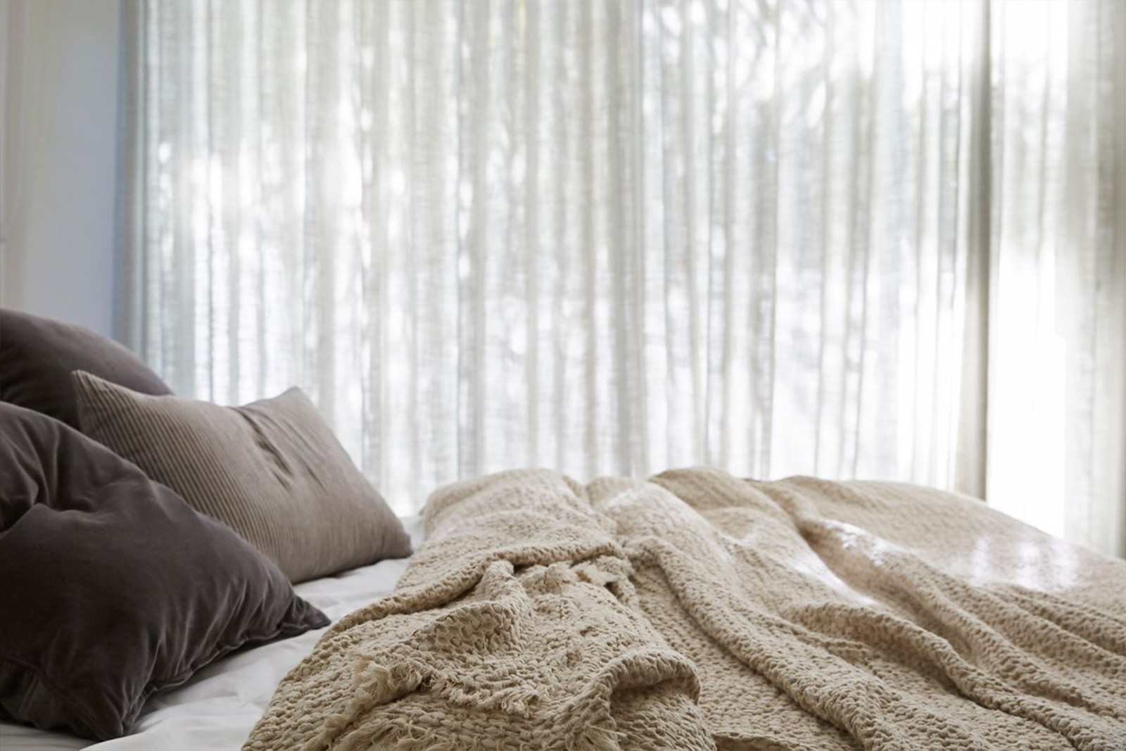 Layered linen on a bed at The Chalet, Byron Beach Abodes