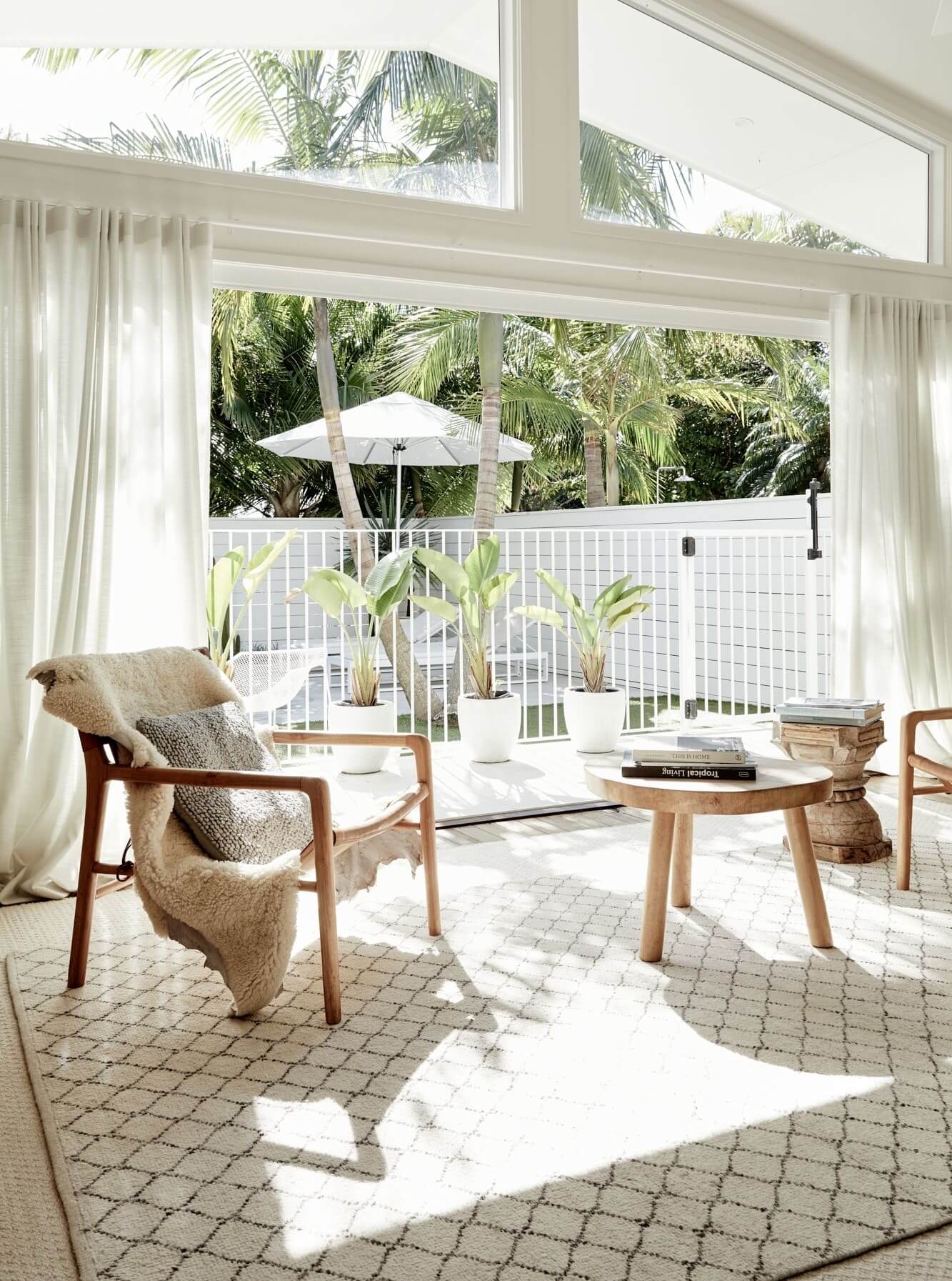 Sitting room at The Chalet, Byron Beach Abodes overlooking the pool, lawn and garden