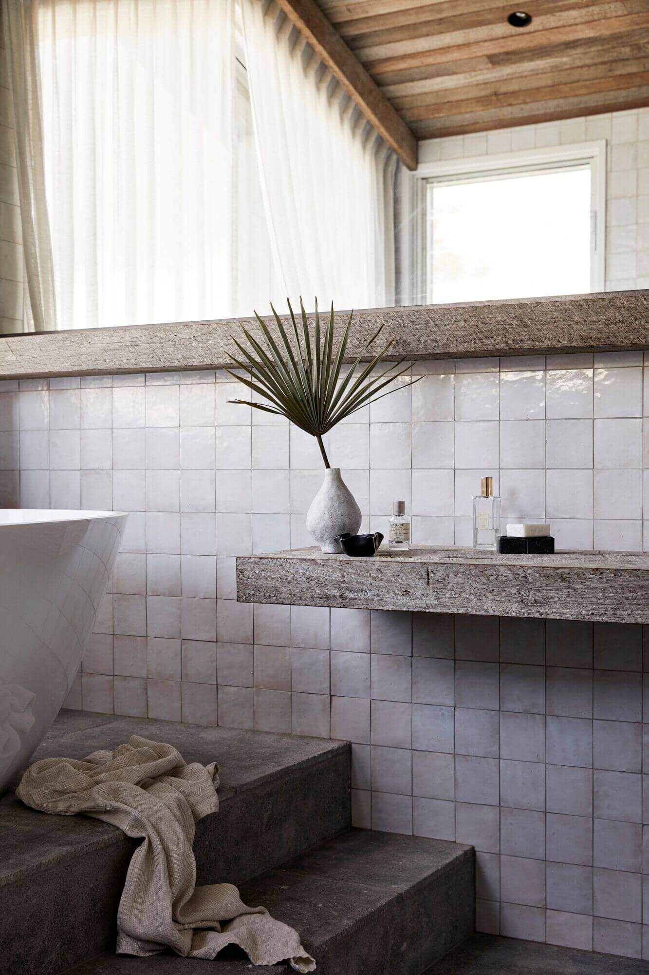 Details of the master ensuite at The Lodge, Byron Beach Abodes with custom timber vanity shelf and handmade square wall tiles