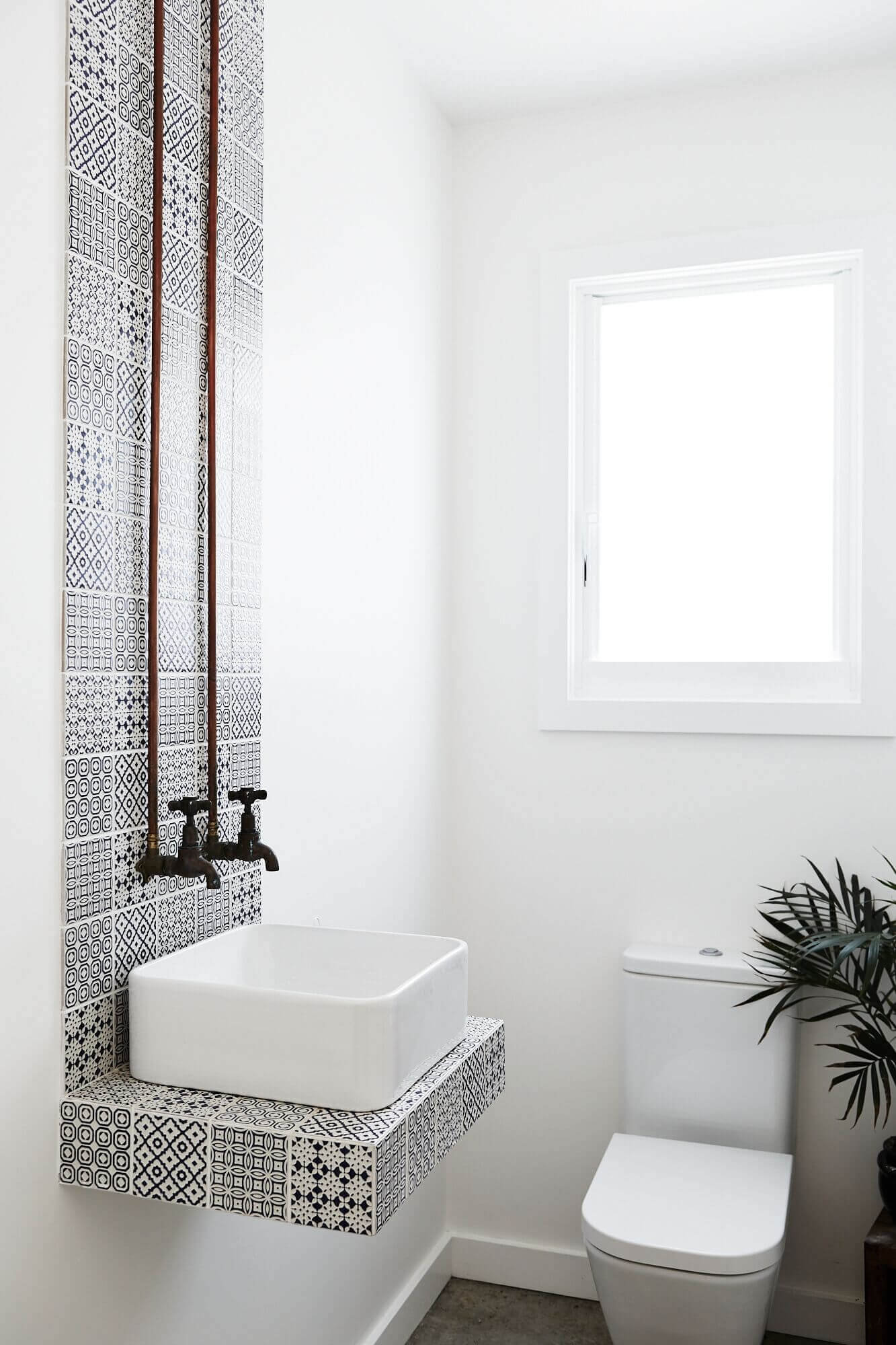 Powder room at Magnolia House, Byron Beach Abodes with printed tile feature